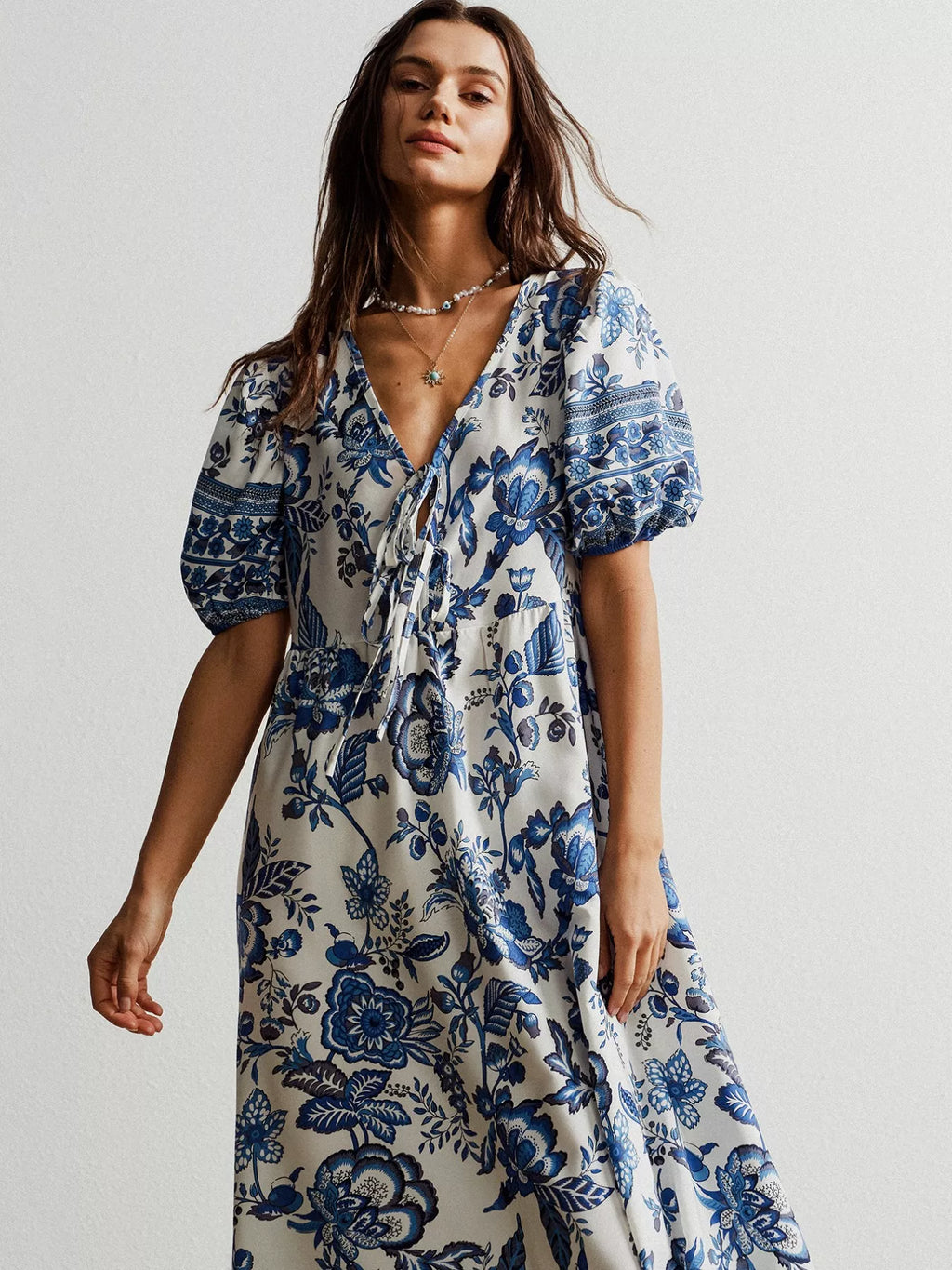 Women in white and blue floral dress